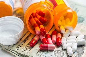 prescription drugs spilled out over money which is covered with maryland medicaid