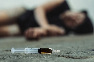 Overdosed victim and a syringe. Medically assisted treatment helps patients to overcome addiction